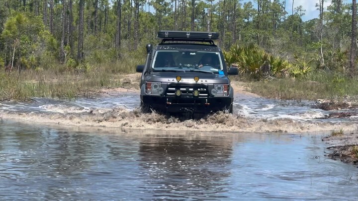 Land Rover crossing deep water on a flooded trail