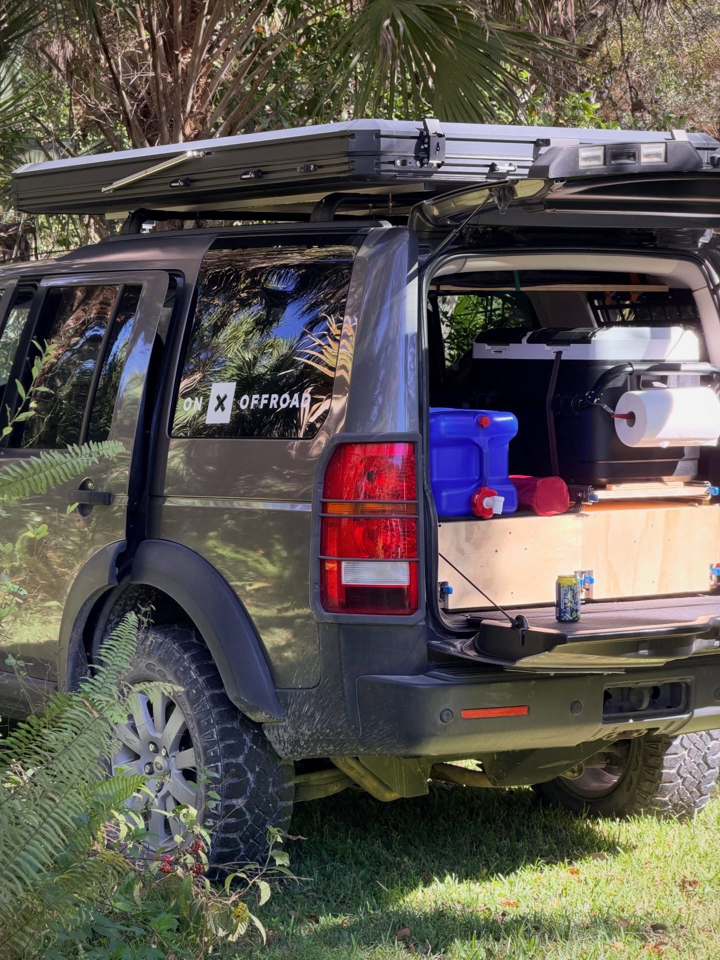 Overland vehicle loaded with gear for transport